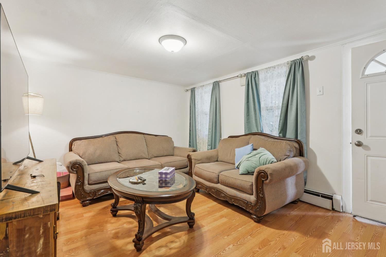 655 Charles Street Perth Amboy, NJ 08861 - Photo 3 of 29 a living room with furniture and a gate