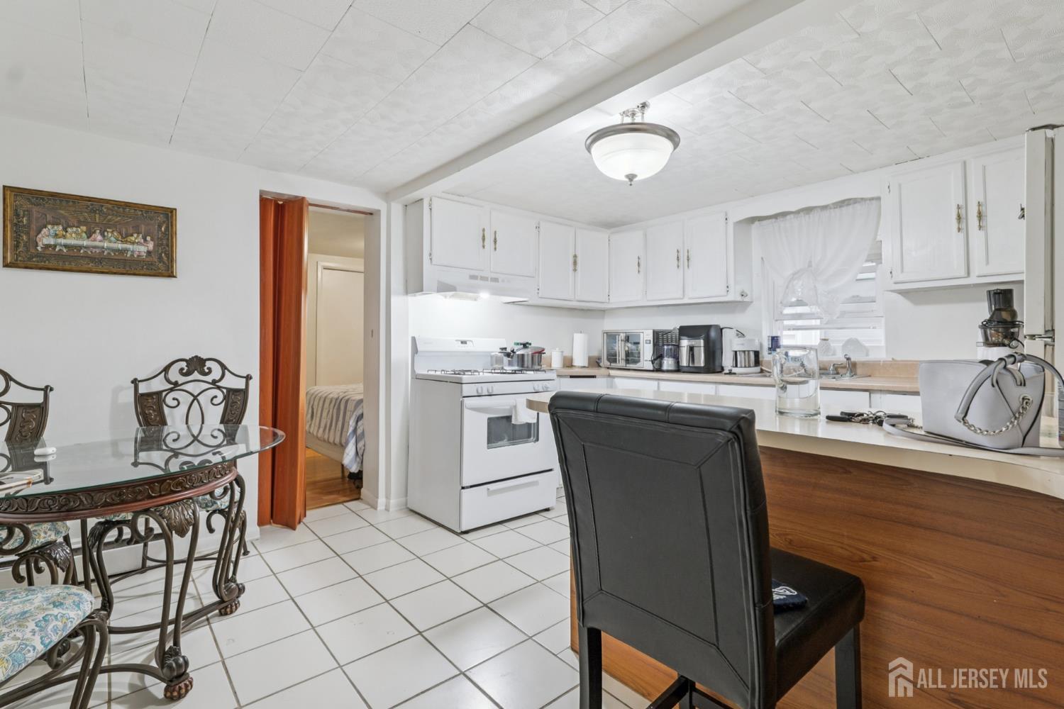 655 Charles Street Perth Amboy, NJ 08861 - Photo 4 of 29 a kitchen with granite countertop a sink cabinets and stainless steel appliances