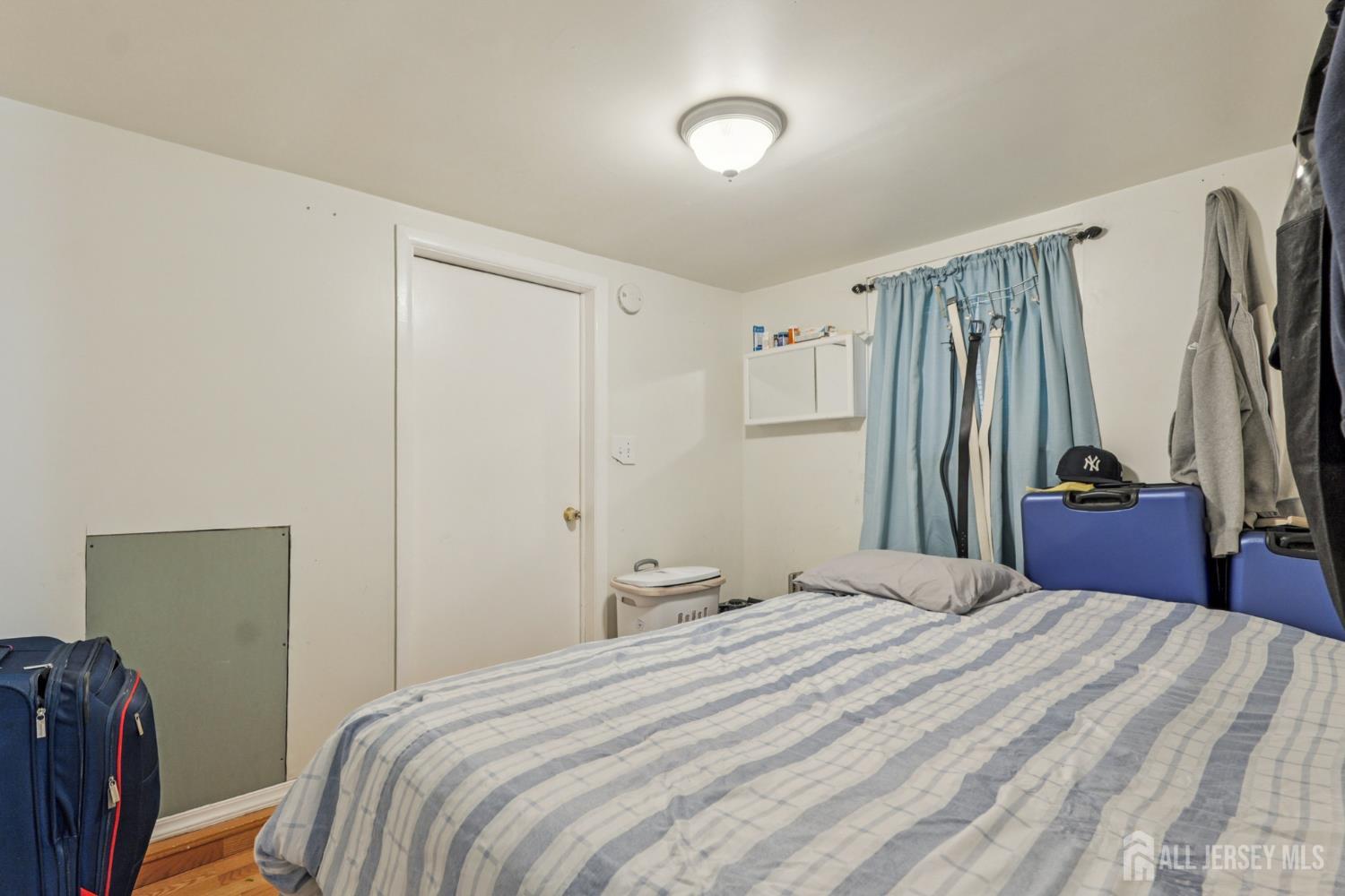 655 Charles Street Perth Amboy, NJ 08861 - Photo 7 of 29 a bedroom with a bed and a closet
