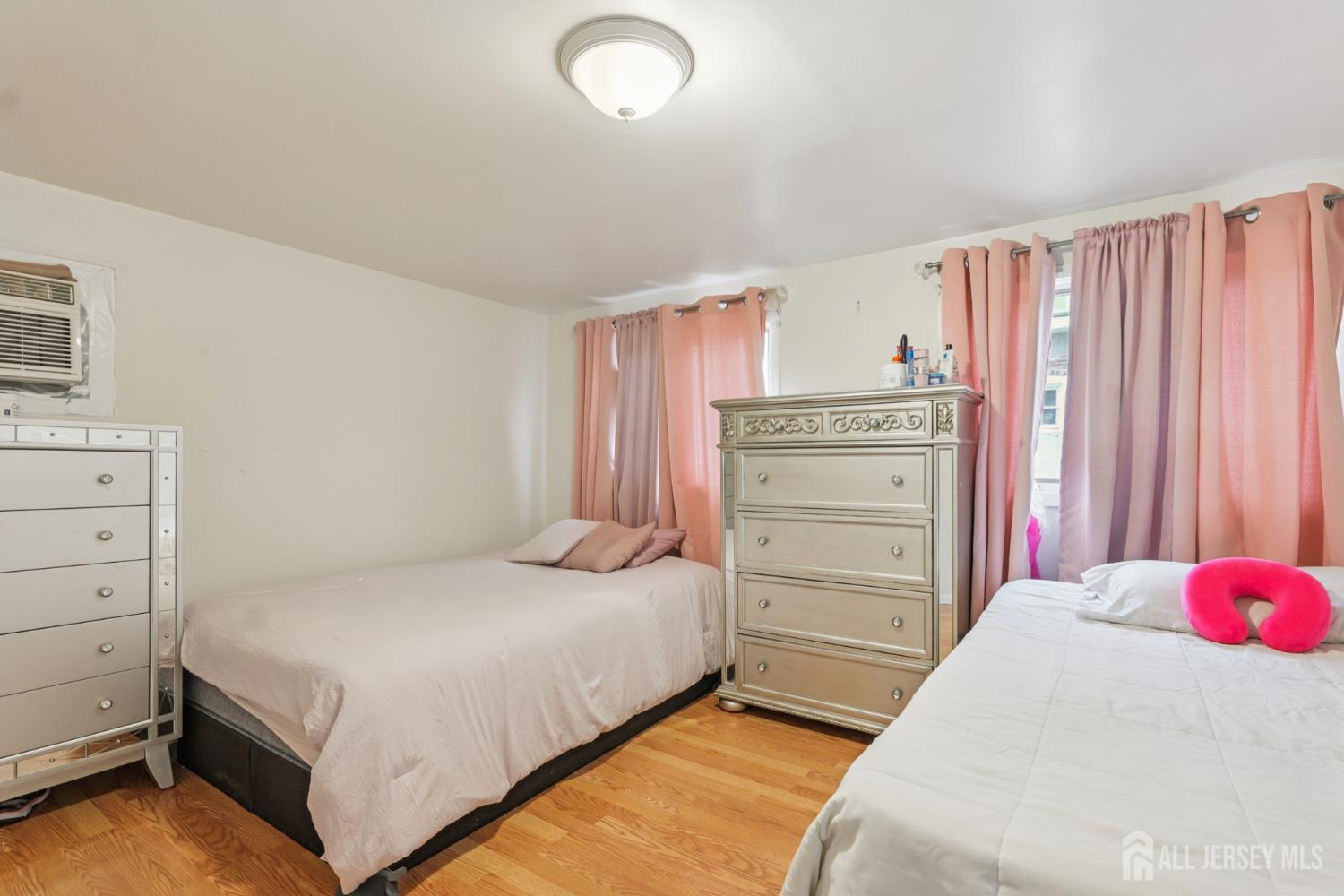 655 Charles Street Perth Amboy, NJ 08861 - Photo 9 of 29 a bedroom with a bed and a dresser