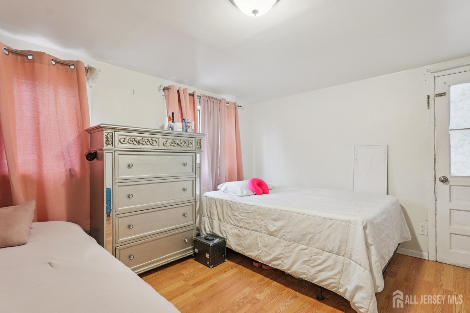 655 Charles Street Perth Amboy, NJ 08861 - Photo 10 of 29 a bedroom with a bed and a window