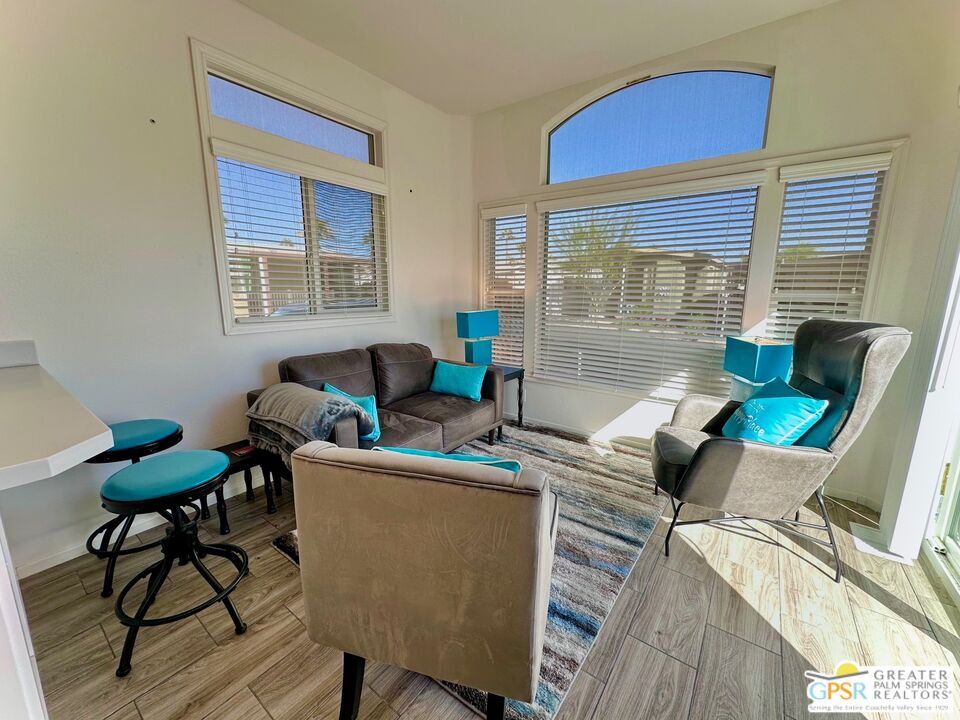 69801 Ramon Road, Unit 228 Cathedral City, CA 92234 - Photo 2 of 12 a living room with furniture and a window