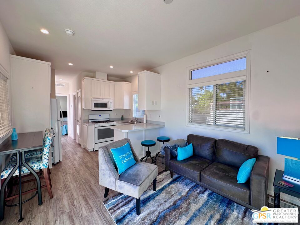 69801 Ramon Road, Unit 228 Cathedral City, CA 92234 - Photo 4 of 12 a living room with furniture and a large window