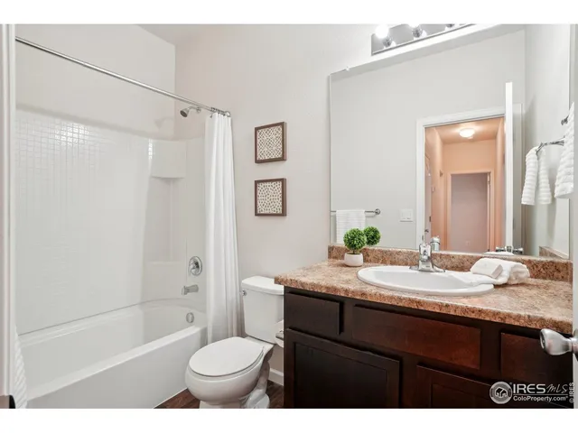a bathroom with a sink toilet vanity and shower