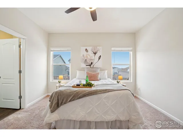 a bedroom with a bed and a painting on the wall