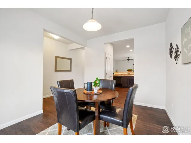a dining room with furniture and wooden floor