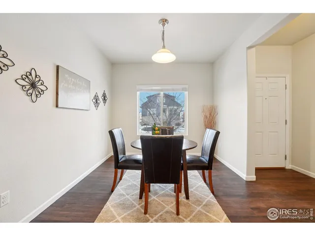 a view of a dining room with furniture wooden floor and a chandelier