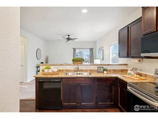 a kitchen with a sink a stove and cabinets