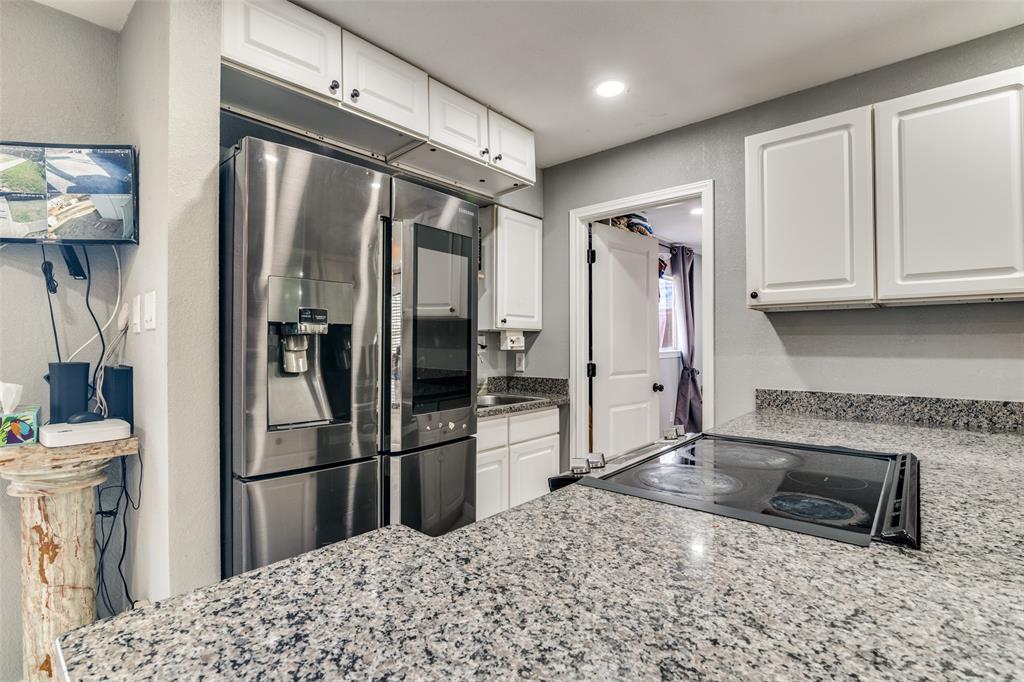 650 Pleasant Oaks Drive Dallas, TX 75217 - Photo 12 of 25 a kitchen with stainless steel appliances granite countertop a refrigerator a stove and a sink