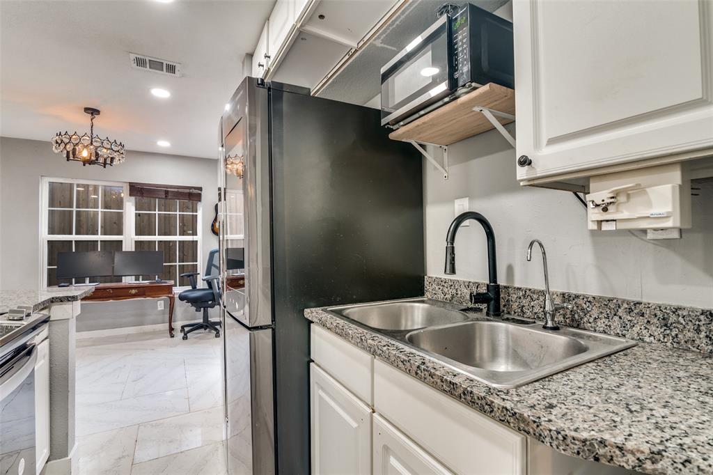 650 Pleasant Oaks Drive Dallas, TX 75217 - Photo 13 of 25 a kitchen with a sink and cabinets
