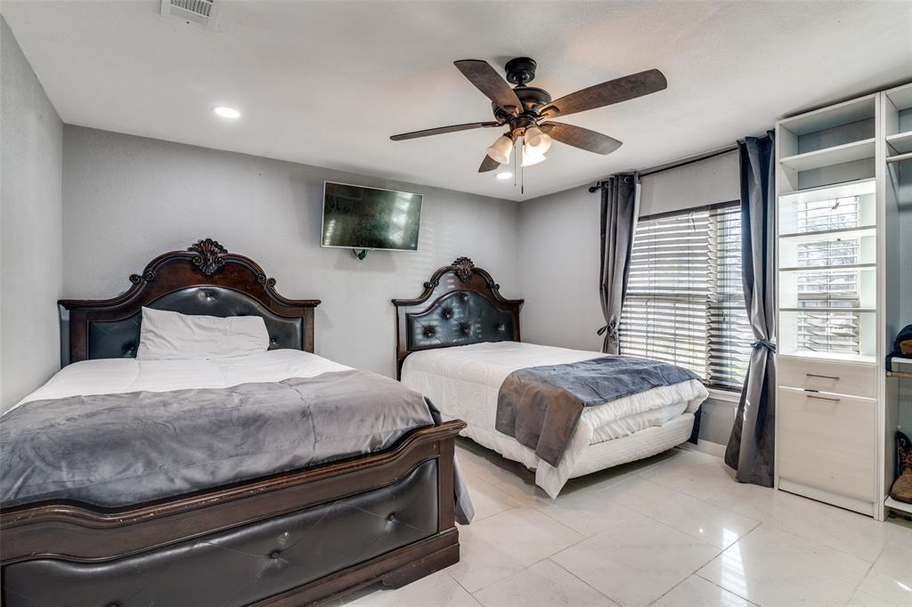 650 Pleasant Oaks Drive Dallas, TX 75217 - Photo 15 of 25 a bedroom with two beds and ceiling fan