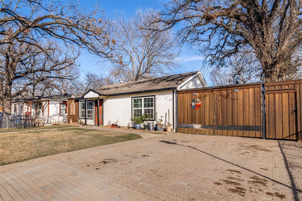 650 Pleasant Oaks Drive Dallas, TX 75217 - Photo 2 of 25 a front view of a house with a basket ball court and a garage