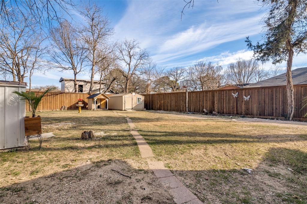 650 Pleasant Oaks Drive Dallas, TX 75217 - Photo 22 of 25 a view of a house with a yard