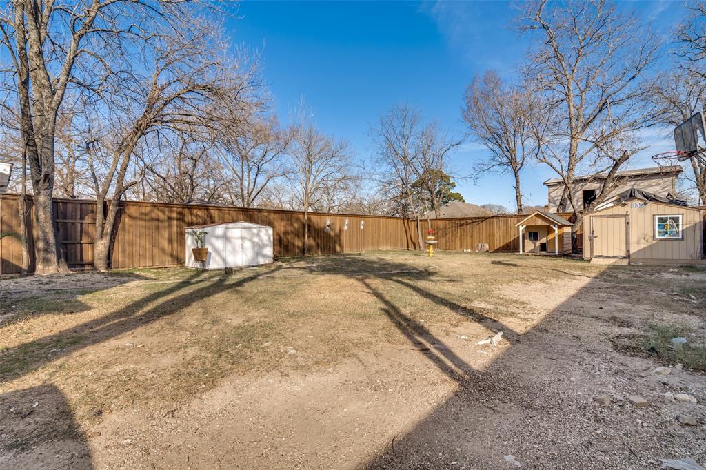 650 Pleasant Oaks Drive Dallas, TX 75217 - Photo 23 of 25 a view of a yard with snow on the road