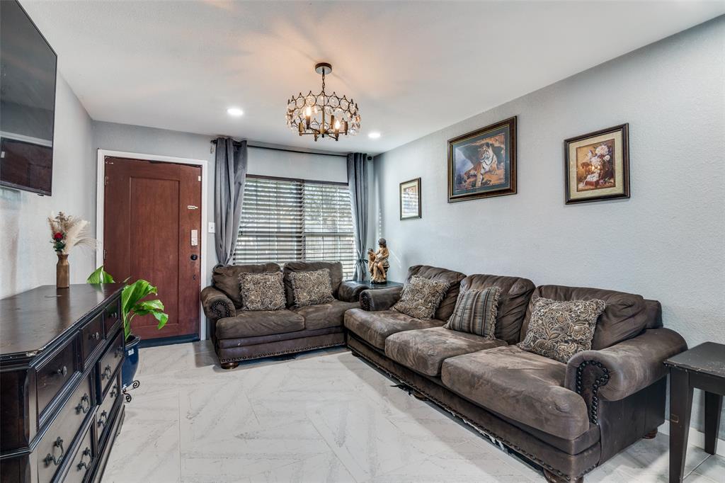650 Pleasant Oaks Drive Dallas, TX 75217 - Photo 5 of 25 a living room with furniture a chandelier and a window