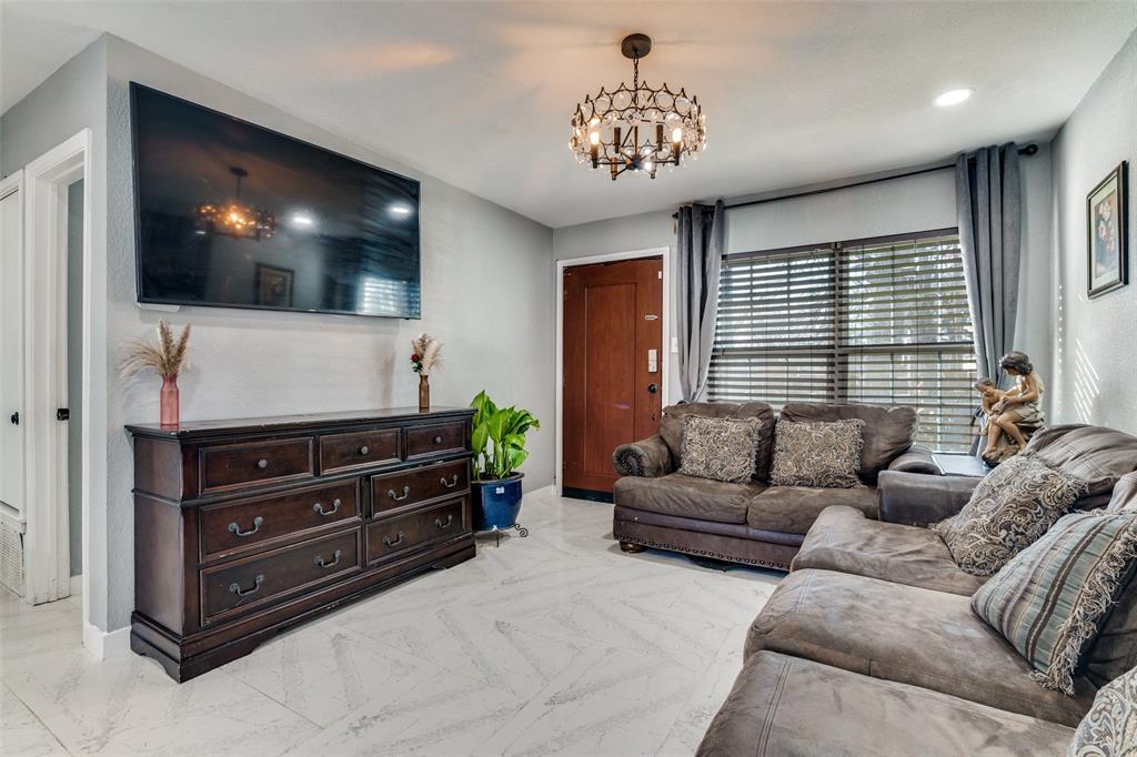 650 Pleasant Oaks Drive Dallas, TX 75217 - Photo 6 of 25 a living room with furniture and a flat screen tv