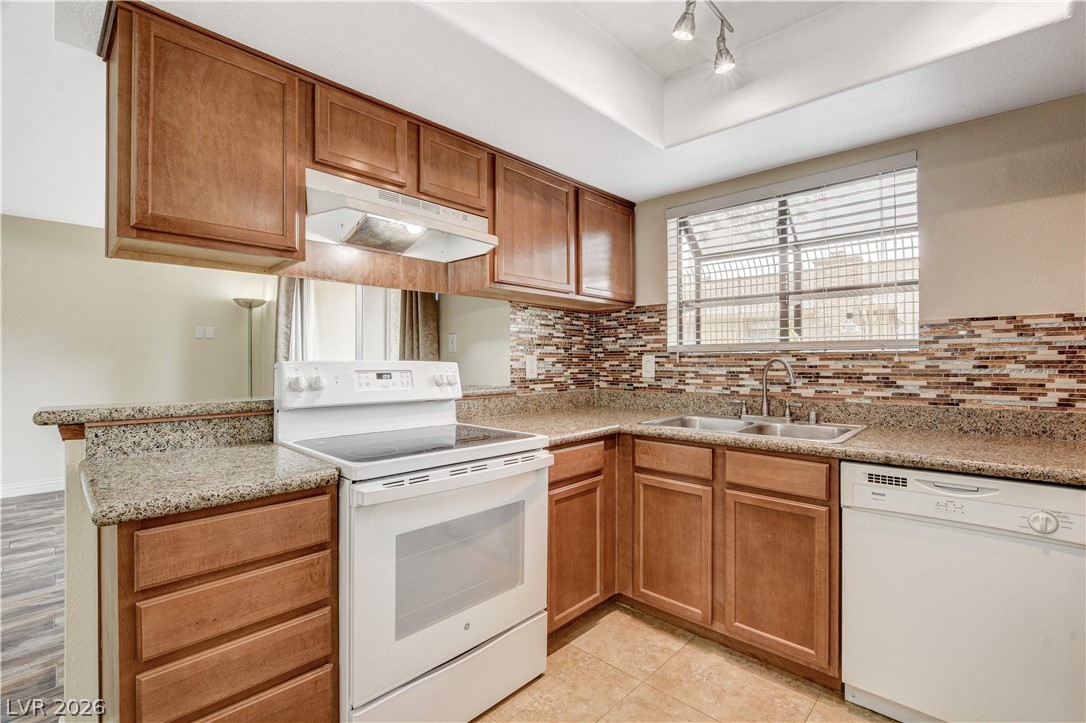 7200 West Pirates Cove Road, Unit 1026 Las Vegas, NV 89145 - Photo 13 of 35 This functional kitchen features ample counter space and natural light, perfect for culinary endeavors.