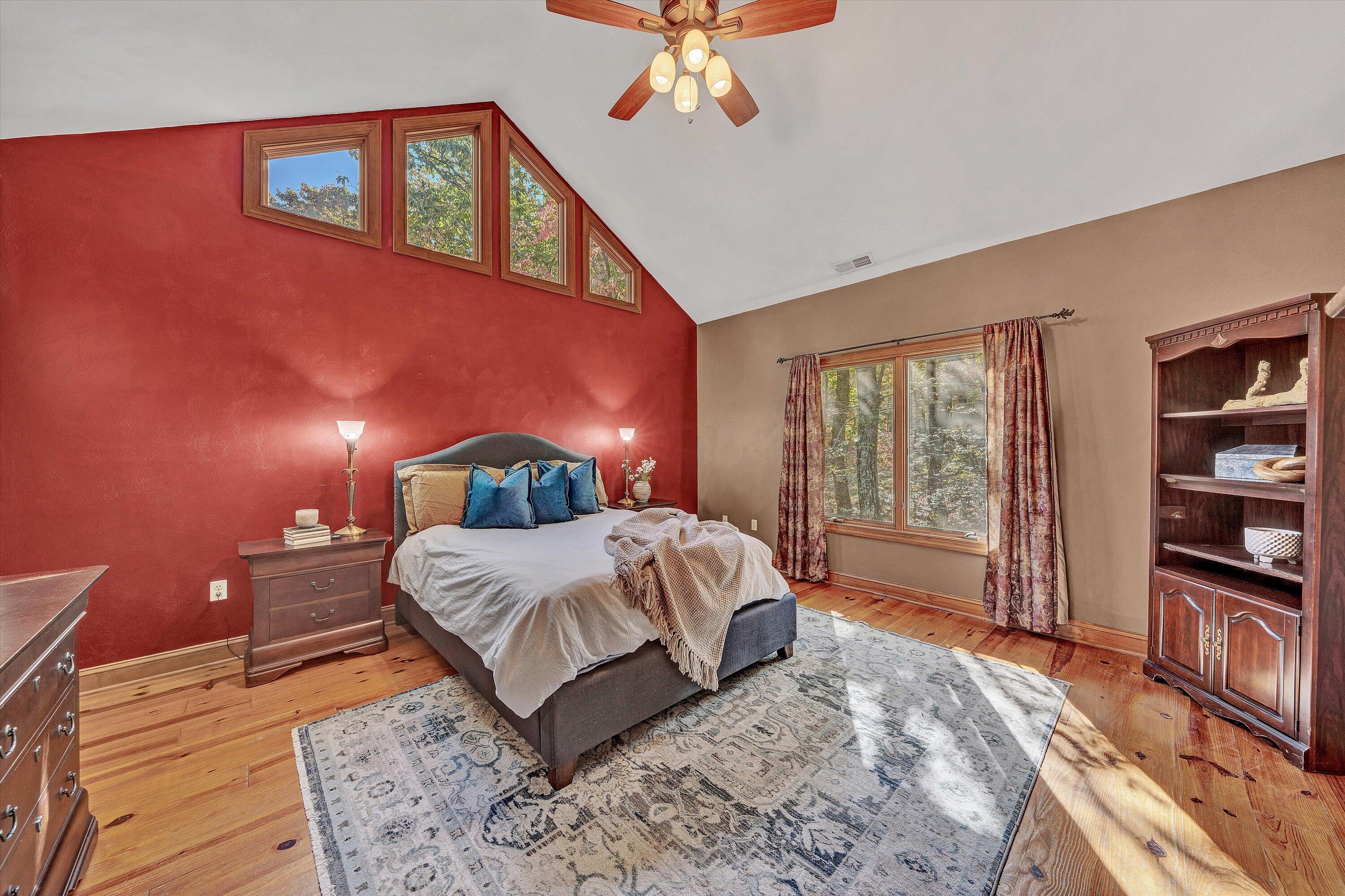 30 Boulder Point Drive Hardy, VA 24101 - Photo 25 of 68 a bedroom with a large bed and a chandelier