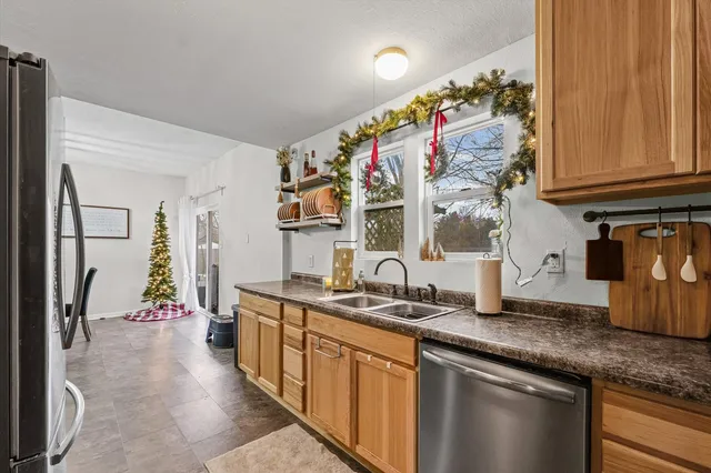 a kitchen with stainless steel appliances granite countertop a sink and cabinets