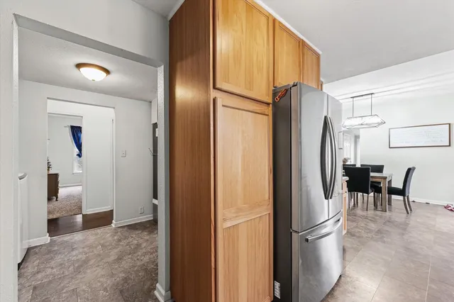 a view of kitchen with furniture and refrigerator