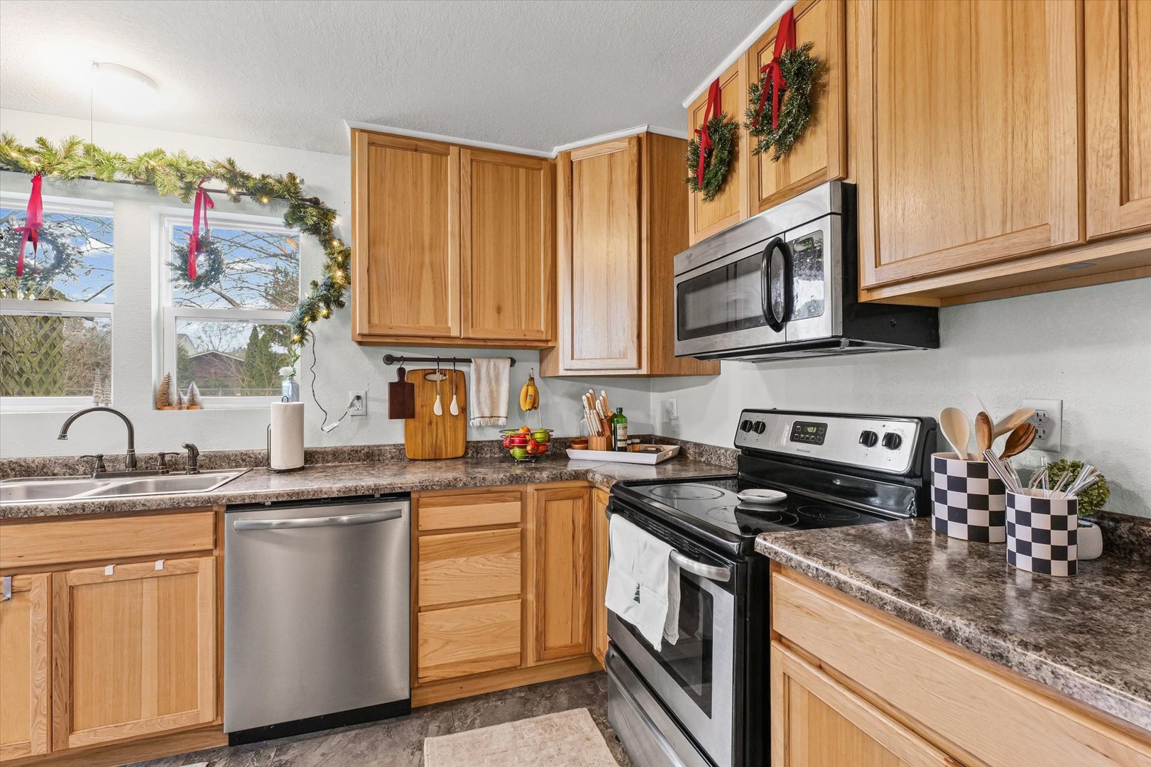 113 Witt Park Road Sidney, IL 61877 - Photo 14 of 29 a kitchen with stainless steel appliances granite countertop a sink dishwasher stove and cabinets with wooden floor