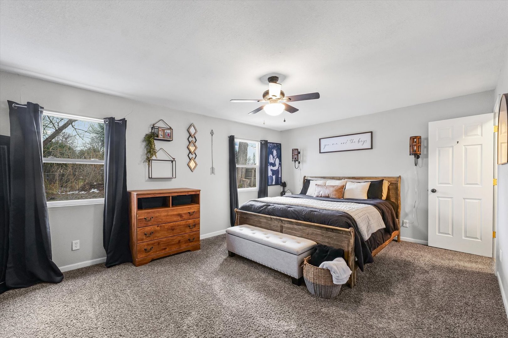 113 Witt Park Road Sidney, IL 61877 - Photo 21 of 29 a spacious bedroom with a bed and a chandelier