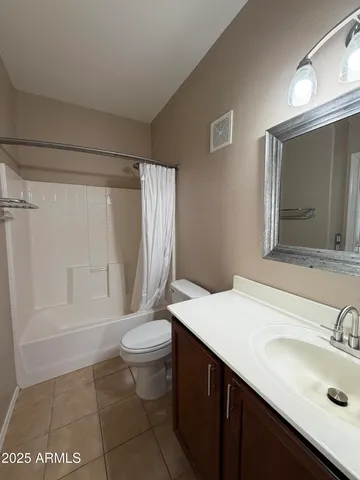 an empty room with a ceiling fan and a window