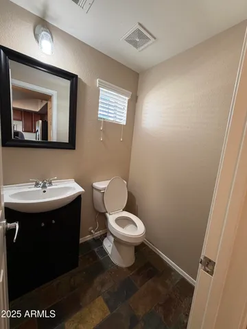 a bathroom with a sink toilet and mirror
