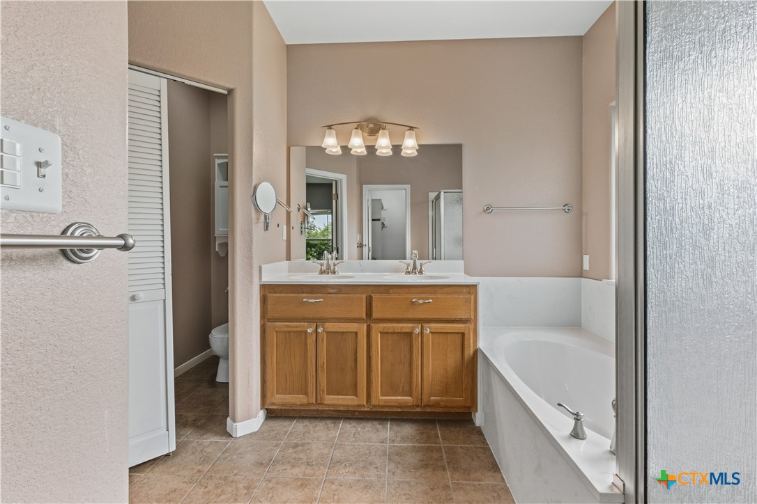 283 County Road 4710 Kempner, TX 76539 - Photo 26 of 47 a bathroom with a bathtub sink and mirror