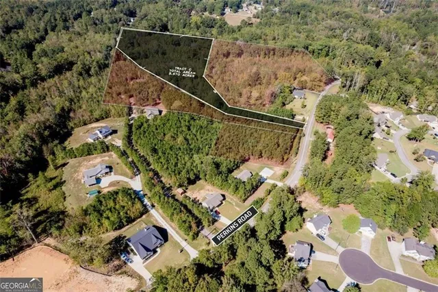 an aerial view of a residential houses with yard