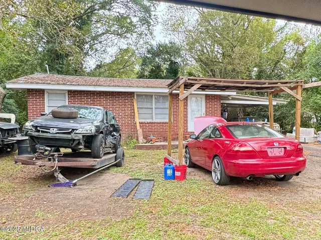a backyard of a house with yard fire pit and outdoor seating