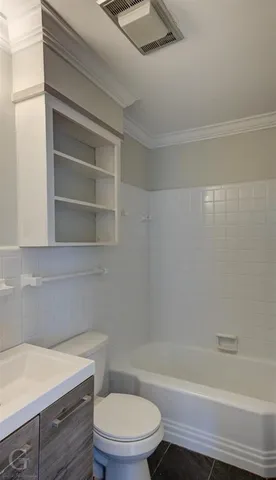 a bathroom with a toilet a sink and bathtub