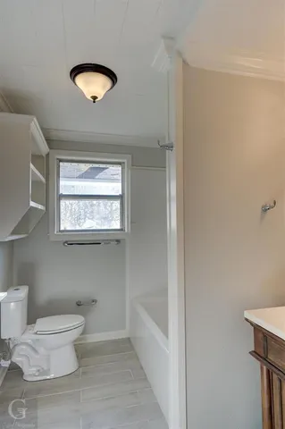 a bathroom with a toilet sink and tub