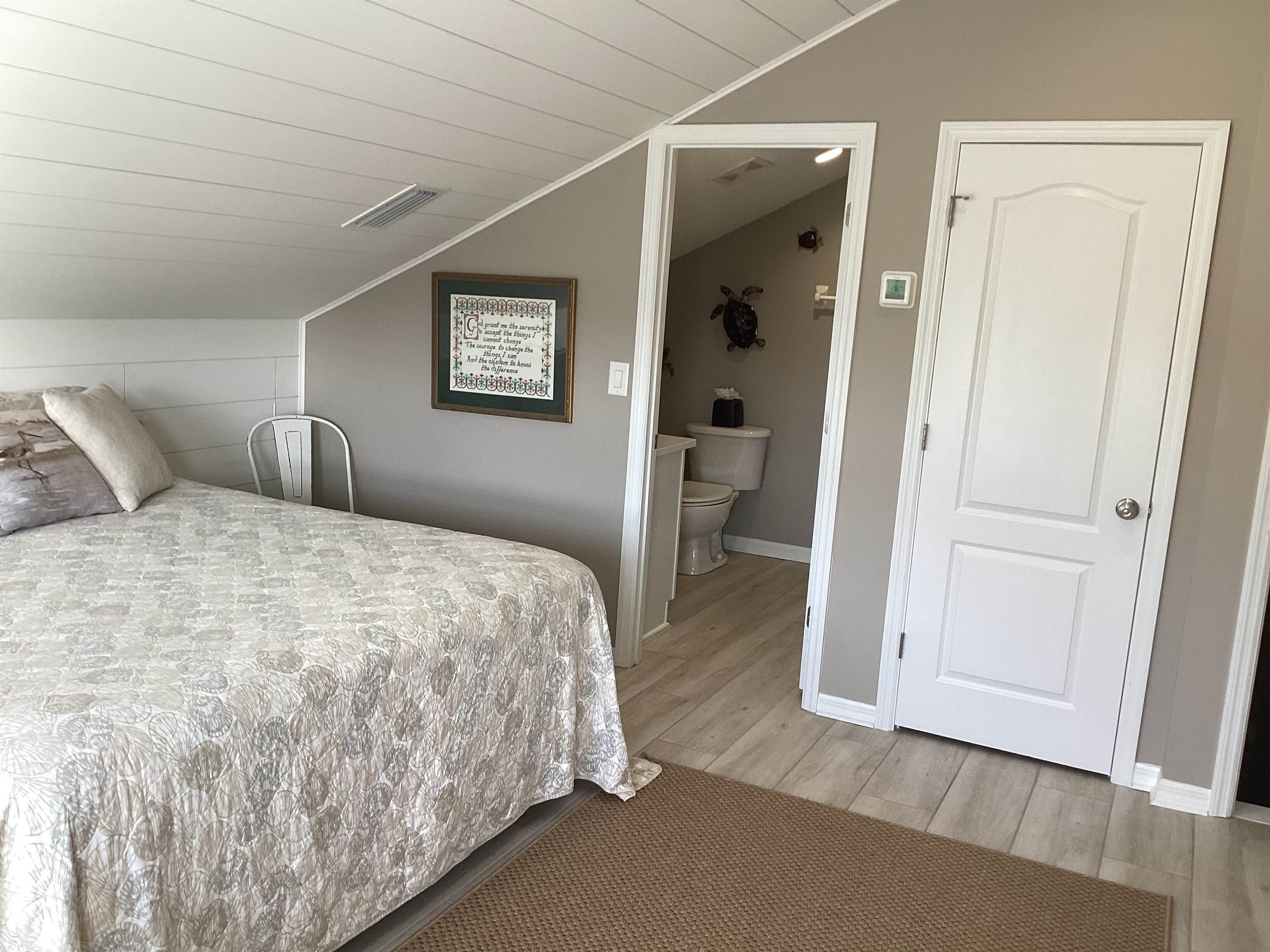 776 Ocean Palm Way St. Augustine, FL 32080 - Photo 26 of 38 a bedroom with a bed and a table
