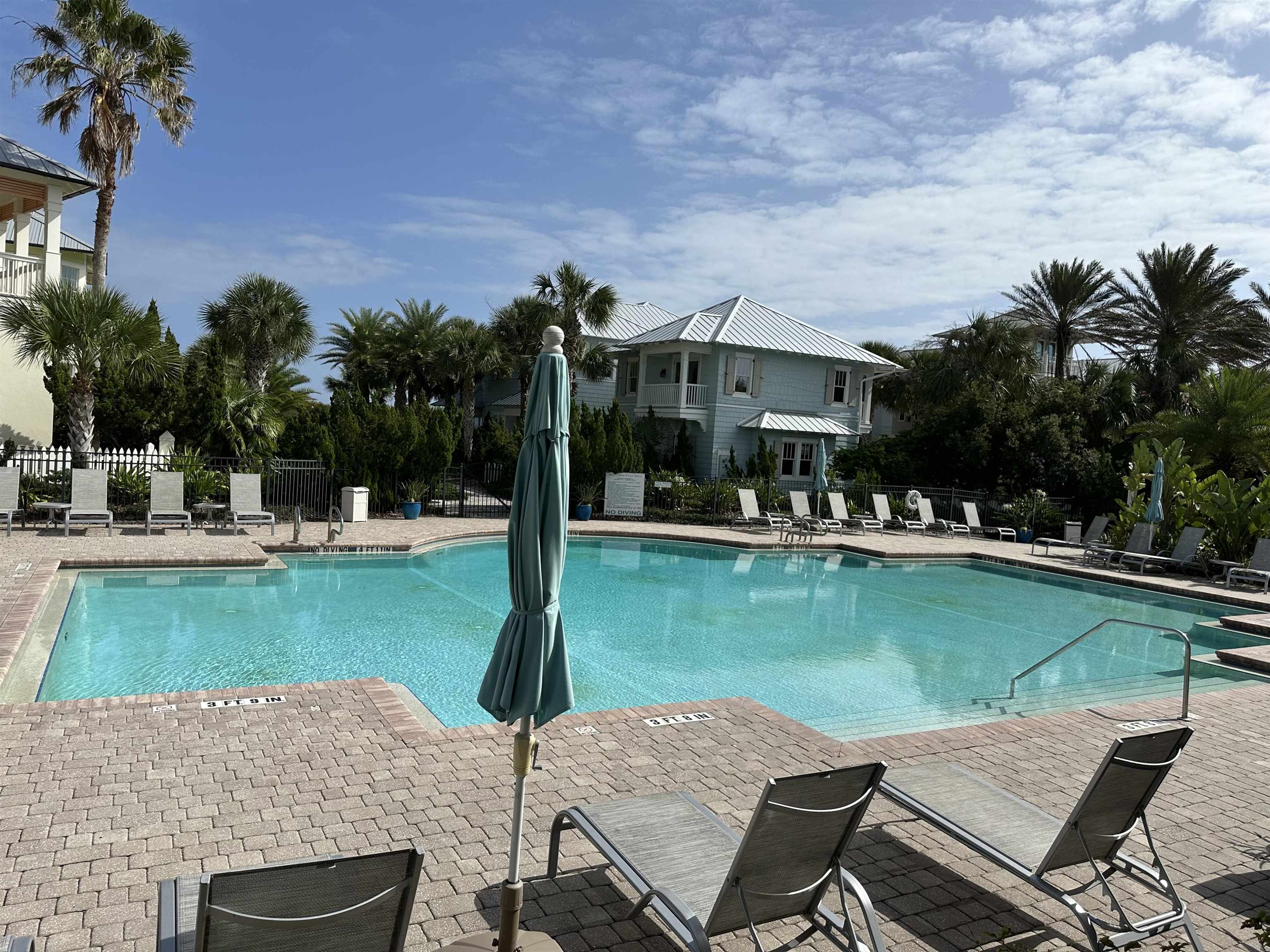 776 Ocean Palm Way St. Augustine, FL 32080 - Photo 34 of 38 a view of a swimming pool and lounge chairs in patio with a lake view