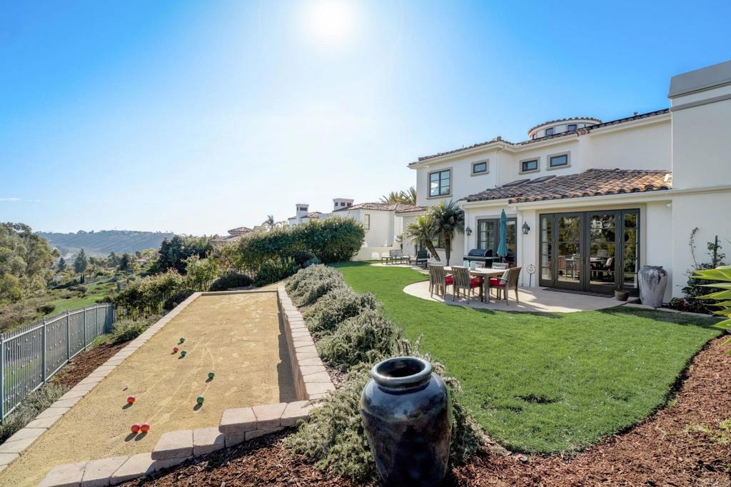 7180 Aviara Drive Carlsbad, CA 92011 - Photo 23 of 43 a view of a swimming pool and fire pit in the backyard