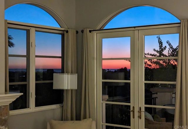 a bedroom with a bed and glass window
