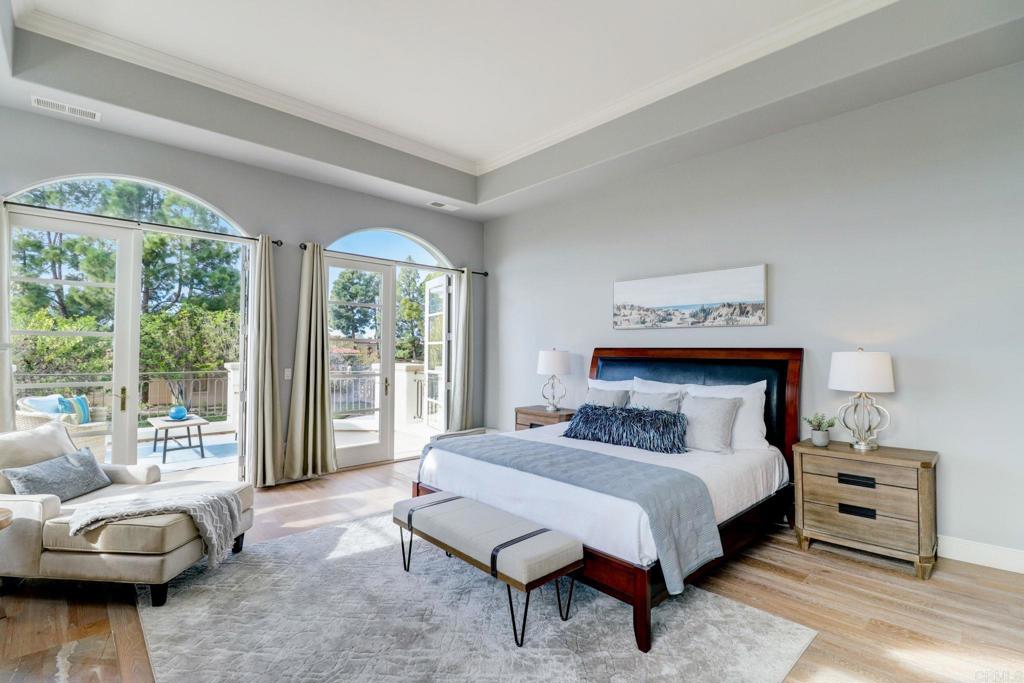 7180 Aviara Drive Carlsbad, CA 92011 - Photo 29 of 43 a bedroom with a bed and glass window
