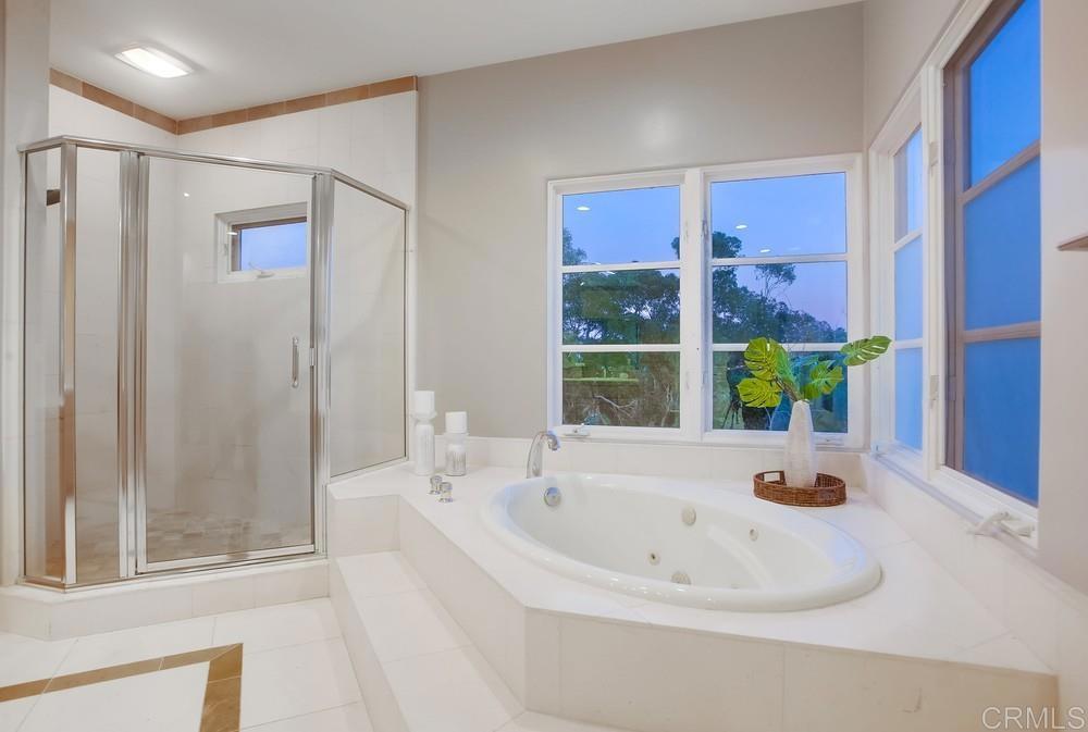 7180 Aviara Drive Carlsbad, CA 92011 - Photo 30 of 43 a white bath tub sitting in a bathroom next to a window