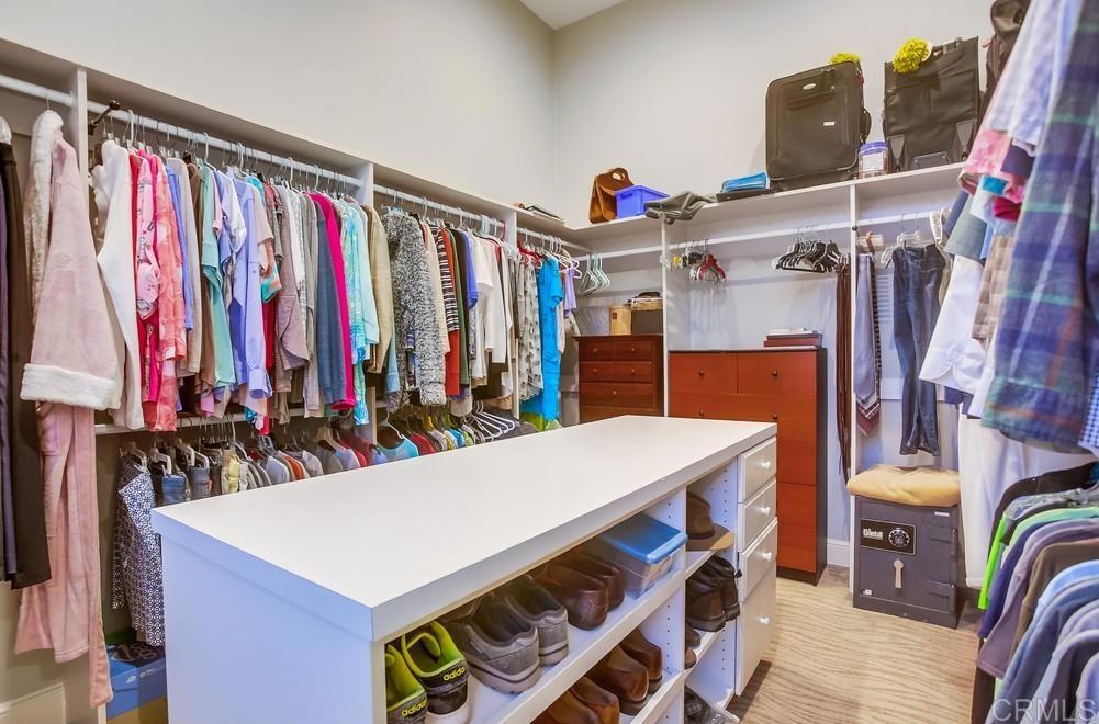 7180 Aviara Drive Carlsbad, CA 92011 - Photo 34 of 43 a view of walk in closet with clothes and shoes