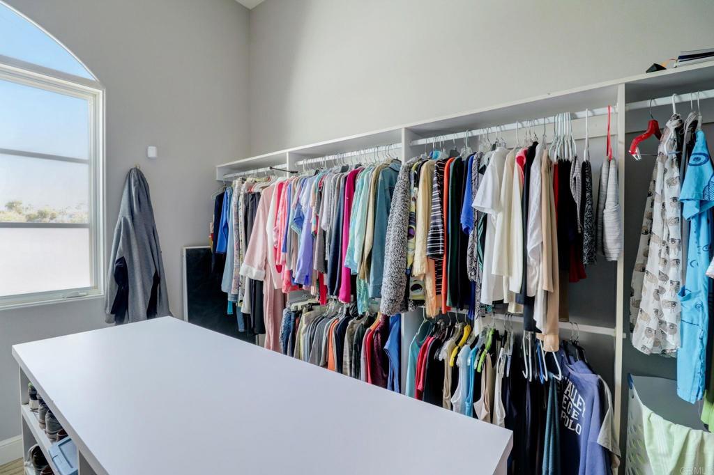 7180 Aviara Drive Carlsbad, CA 92011 - Photo 36 of 43 a view of walk in closet with clothes