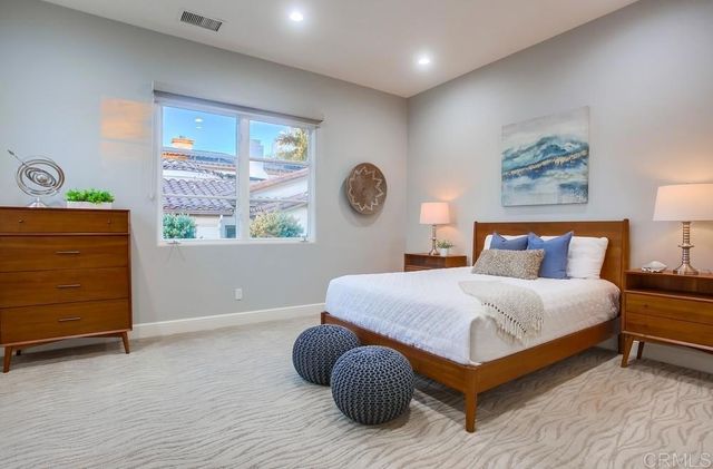 a bedroom with a large window and a bed