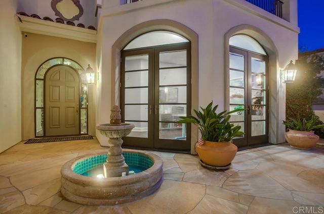 a view of a glass door with a potted plant in front of a door