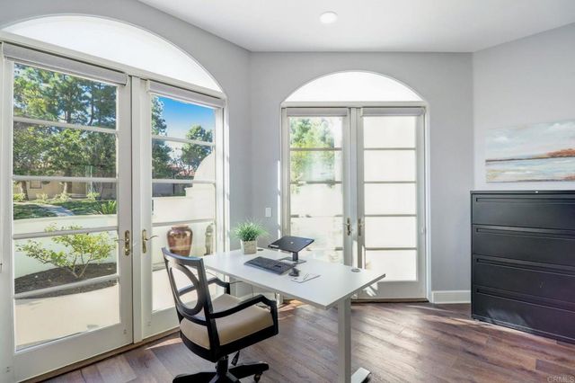 a workspace with wooden floor and a window