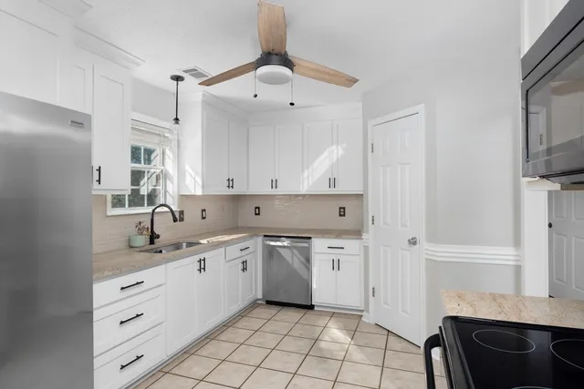a kitchen with a sink cabinets and window