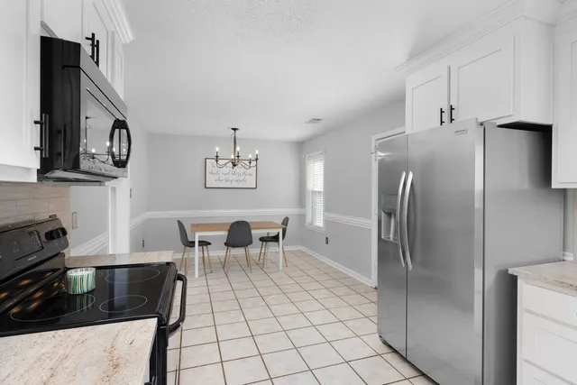 a kitchen with stainless steel appliances a refrigerator and a stove top oven