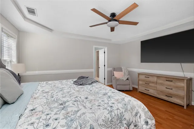 a bedroom with a bed and a flat screen tv