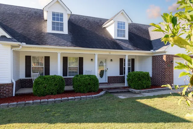 a front view of a house with garden and porch