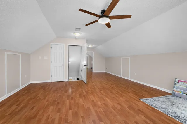 a bedroom with a bed and a view of kitchen