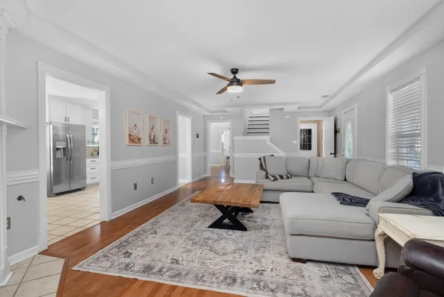 a living room with furniture and wooden floor